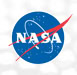 NASA's blue circular logo with white letters, a red vector, and a white orbital path on a light background.